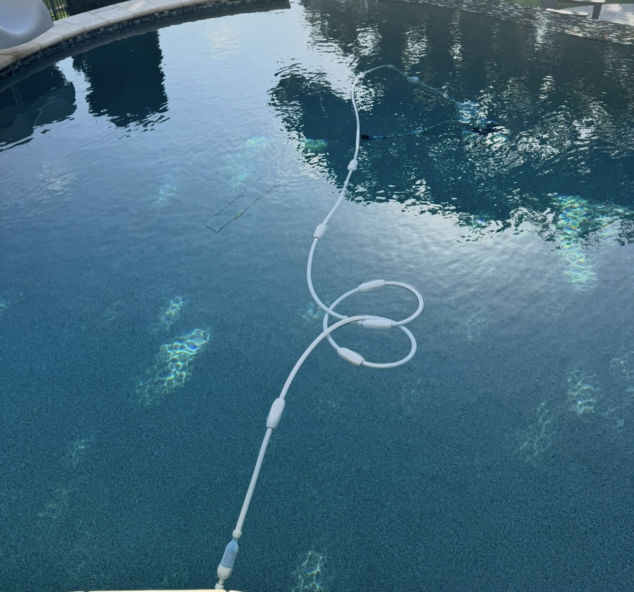 Customer pool showing DRAGON HOSE Stabilizers installed on the cleaner hose